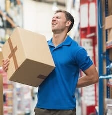 warehouse worker with back pain needing 5 lifestyle changes to prevent back pain