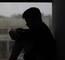 man feeling joint pain from rain storm and needing an orthopedic clinic